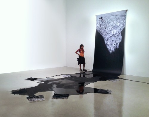 Mwangi Hutter. Aesthetic of Uprising II, 2011. Installation view, Pitzer Art Galleries, Claremont CA. Print on roll, black paint, cleaning rags with text, dimensions variable. Courtesy of the artist.